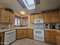 Well-equipped kitchen featuring wood cabinets and skylights at 650 N Hawes Rd # 4820, Mesa, AZ 85207