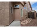 Home's entry with tan door and stone pathway at 6610 E University Dr # 157, Mesa, AZ 85205