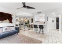 Inviting living room boasts a modern ceiling fan, cozy sofa, and seamless access to the kitchen at 7777 E 2Nd St # 101, Scottsdale, AZ 85251