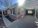 Side view of the house with a brick patio and pergola at 801 W Earll Dr, Phoenix, AZ 85013