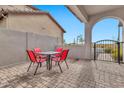 Cozy patio with red chairs and a wrought-iron gate at 8334 E Inca St, Mesa, AZ 85207