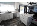 Modern kitchen island with white cabinets and quartz countertops at 903 W Loughlin Dr, Chandler, AZ 85225