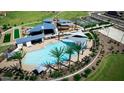 Aerial view of community pool with shaded seating and nearby amenities at 921 W Finch Dr, San Tan Valley, AZ 85140