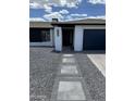 Modern entryway with walkway and dark-colored garage door at 941 W Peralta Ave, Mesa, AZ 85210