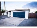 Modern home with a navy blue garage door and freshly painted white exterior at 941 W Peralta Ave, Mesa, AZ 85210