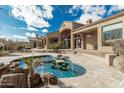 Freeform swimming pool and spa with a swim-up bar at 14047 E Lowden Ct, Scottsdale, AZ 85262