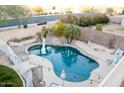 Inviting kidney-shaped pool with surrounding patio and landscaping at 1414 N Estrada --, Mesa, AZ 85207