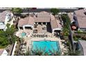 Stunning aerial view of the backyard oasis featuring a sparkling pool, spa, and multiple lounge areas perfect for entertaining at 14200 W Village Pkwy # 113, Litchfield Park, AZ 85340