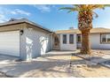 Front entrance with an ornate metal door and a paved walkway at 14219 N 51St Dr, Glendale, AZ 85306