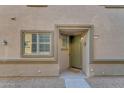 Townhome entry with green door and neutral-colored walls at 1448 N 80Th Dr, Phoenix, AZ 85043