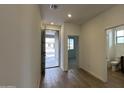 Open entryway with tile floors, a view to the backyard, and access to a bathroom at 15797 W Hackamore Dr, Surprise, AZ 85387