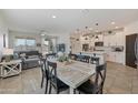Open concept kitchen and dining area with white cabinets and an island at 17403 W Eagle Ct, Goodyear, AZ 85338