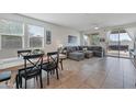 Spacious living room with gray sectional sofa and access to backyard at 17403 W Eagle Ct, Goodyear, AZ 85338