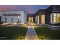 Welcoming front entry with a stone walkway and landscape lighting at 23311 N 95Th Dr, Peoria, AZ 85383