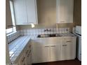Bright kitchen features white cabinets and tile countertops at 2945 N 19Th Ave # 67, Phoenix, AZ 85015