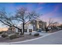 Luxury home exterior at dusk, showcasing its architecture and landscaping at 6213 W Saguaro Park Ln, Glendale, AZ 85310