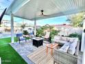 Outdoor patio with seating area, fire pit, and view of pool at 8114 E Clarendon Ave, Scottsdale, AZ 85251