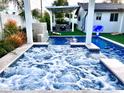 Inviting spa with patterned tile and waterfall feature at 8114 E Clarendon Ave, Scottsdale, AZ 85251