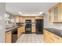 Modern kitchen with wood cabinets and black appliances at 1029 E Lodge Dr, Tempe, AZ 85283