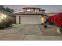 Two-story house with attached garage, landscaping, and a paved driveway at 10760 W Monte Vista Rd, Avondale, AZ 85392