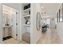 Bright entryway with built-in shelving, bench, and powder room at 10994 W Mckinley St, Avondale, AZ 85323