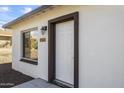 White front door entry with dark brown trim and window at 1423 E Cholla St, Phoenix, AZ 85020