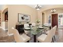 Elegant dining room with a glass table and chandelier at 1807 W Sierra Sunset Trl, Phoenix, AZ 85085