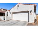 White two-car garage with driveway at 18254 W Via Montoya Dr, Surprise, AZ 85387