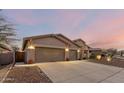 Attractive two-story home with a two-car garage at dusk at 18645 W Mcneil St, Goodyear, AZ 85338