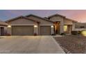Two-story house with a three-car garage and desert landscaping at 18645 W Mcneil St, Goodyear, AZ 85338