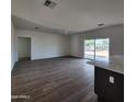Spacious living area with tile floors and sliding glass doors at 22254 W Skinner Rd, Wittmann, AZ 85361