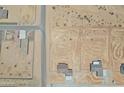 An aerial view of homes and neighborhoods in a desert landscape with paved streets and desert vegetation at 22270 W Skinner Rd, Wittmann, AZ 85361