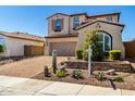 Beautiful two-story home with a desert landscape, brick driveway, and a neatly manicured front yard at 30704 N 138Th Ave, Peoria, AZ 85383