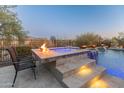 Relax in the luxurious spa with waterfall feature at 41717 N Harbour Town Way, Anthem, AZ 85086