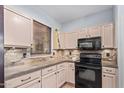 Bright kitchen features updated countertops and cabinetry at 44783 W Alamendras St, Maricopa, AZ 85139