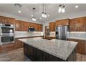 Modern kitchen with granite countertops and dark wood island at 4950 Black Mountain Rd, Wickenburg, AZ 85390