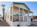 Single-wide manufactured home with carport, steps, and covered porch at 5201 W Camelback Rd # F316, Phoenix, AZ 85031