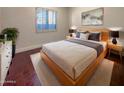 Light and airy bedroom with hardwood floors and a modern bed at 741 N Tower Pl, Chandler, AZ 85225