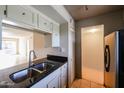 Condo kitchen with granite countertops and stainless steel sink at 7436 E Chaparral Rd # B260, Scottsdale, AZ 85250