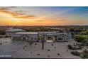 A sprawling desert home with manicured landscaping, stunning sunset views, and mountain scenery at 8110 E Saddle Horn Rd, Scottsdale, AZ 85255