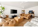 Bright living room with exposed brick wall, leather sofas and large TV at 8521 N 15Th Dr, Phoenix, AZ 85021