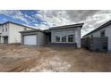 Charming single-story home with gray stucco and a white garage door at 11441 E Utah Ave, Mesa, AZ 85212