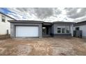 Charming single-story home with gray stucco and a white garage door at 11441 E Utah Ave, Mesa, AZ 85212