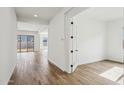 Bright foyer with light wood-look floors and a view into the living spaces at 11441 E Utah Ave, Mesa, AZ 85212