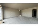 Unfinished garage with visible stud-framing and concrete flooring at 11441 E Utah Ave, Mesa, AZ 85212