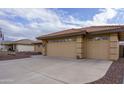 Two-car garage with an attached carport and a flag at 11461 E Natal Ave, Mesa, AZ 85209