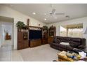 Living room featuring a large TV stand and comfortable seating at 11461 E Natal Ave, Mesa, AZ 85209