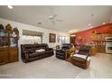 Spacious living room with leather furniture and a view into the kitchen at 11461 E Natal Ave, Mesa, AZ 85209