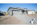 New construction home with gray siding, stone accents, and a two-car garage at 11464 E Utah Ave, Mesa, AZ 85212