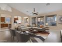 Spacious living room with L-shaped sofa and a view of the kitchen at 14248 W Edgemont Ave, Goodyear, AZ 85395